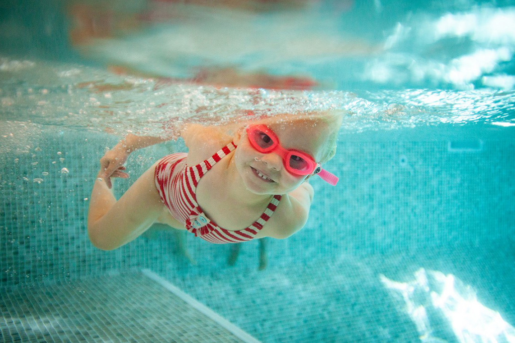 Child swimming in pool.